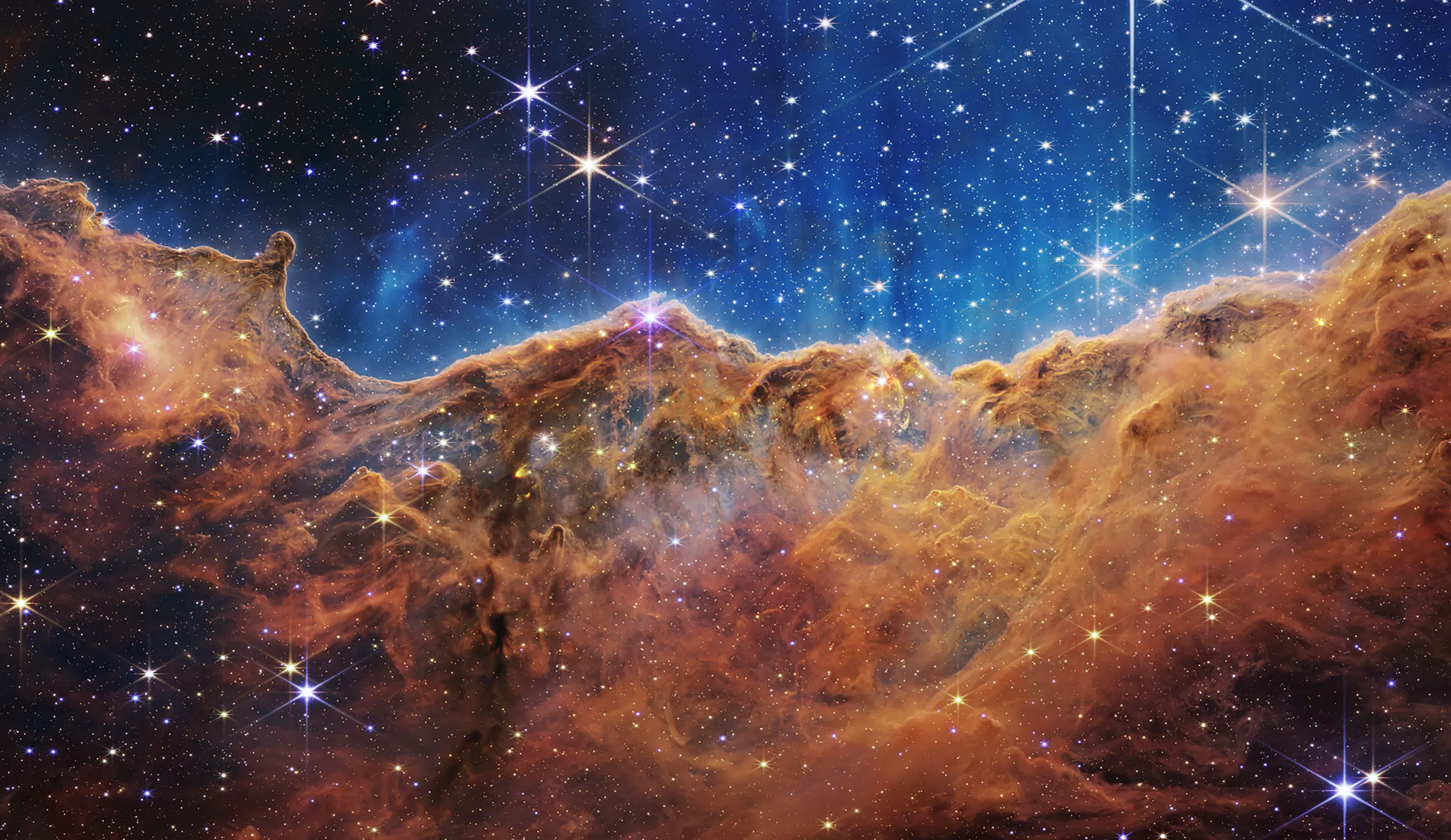 An image of “Cosmic Cliffs” in the Carina Nebula (NIRCam Image) by James Webb Space Telescope